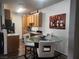 Kitchen/Dining Area featuring a glass table, wood cabinets, and modern appliances at 4730 E Craig Rd # 1155, Las Vegas, NV 89115