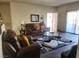 Cozy living room with hardwood floors, ample seating, and a sliding glass door at 4730 E Craig Rd # 1155, Las Vegas, NV 89115