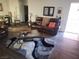 Cozy living room featuring a leather sofa, stylish rug, and modern decor at 4730 E Craig Rd # 1155, Las Vegas, NV 89115