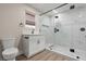Modern bathroom with a glass-enclosed shower, white vanity, and sleek black fixtures at 4805 Jay Ave, Las Vegas, NV 89130