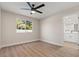 Bright bedroom with laminate flooring, featuring a modern ceiling fan and a large window at 4805 Jay Ave, Las Vegas, NV 89130