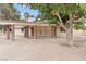 Charming single-story home with a covered patio, complemented by mature trees and desert landscaping at 4805 Jay Ave, Las Vegas, NV 89130