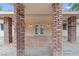 Covered patio with brick columns leading to double doors, creating a welcoming outdoor space at 4805 Jay Ave, Las Vegas, NV 89130