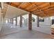 Spacious covered patio featuring exposed wood beams, brick pillars, and ample room for outdoor activities at 4805 Jay Ave, Las Vegas, NV 89130