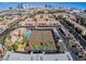 Aerial view of a community featuring tennis courts, a pool, condos, and palm trees at 5185 Indian River Dr # 223, Las Vegas, NV 89103