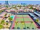 Aerial view of a community featuring tennis courts, a pool, condos, and palm trees at 5185 Indian River Dr # 223, Las Vegas, NV 89103