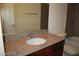 Bathroom vanity features granite counters with a framed mirror at 5185 Indian River Dr # 223, Las Vegas, NV 89103