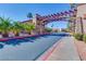 Gated community entrance with a decorative pergola and meticulously maintained landscaping at 5185 Indian River Dr # 223, Las Vegas, NV 89103