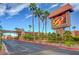Community entrance with lush landscaping, mature palm trees, and an attractive Bella Vita sign at 5185 Indian River Dr # 223, Las Vegas, NV 89103