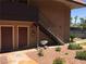Exterior view of community building and entry with stairs, landscaping, and palm trees at 5185 Indian River Dr # 223, Las Vegas, NV 89103