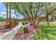 Manicured community grounds with walking path, mature trees, landscaping, and comfortable benches at 5185 Indian River Dr # 223, Las Vegas, NV 89103