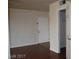 Bright living room with wood floors, white walls, closet view, and a glimpse into other rooms at 5185 Indian River Dr # 223, Las Vegas, NV 89103