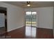Open living room with wood floors, a ceiling fan, and a sliding door to a balcony with tennis court views at 5185 Indian River Dr # 223, Las Vegas, NV 89103