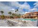 Community pool area with lounge chairs, palm trees, and a multi-story building overlooking the pool at 5185 Indian River Dr # 223, Las Vegas, NV 89103