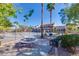 Outdoor community pool area with picnic tables, grills, and palm trees provides residents a place to relax and barbecue at 5185 Indian River Dr # 223, Las Vegas, NV 89103