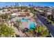 Aerial view of a beautiful community pool surrounded by lush landscaping and palm trees at 5185 Indian River Dr # 223, Las Vegas, NV 89103