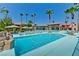 View of the community pool featuring lounge chairs, palm trees, and blue water at 5185 Indian River Dr # 223, Las Vegas, NV 89103