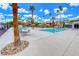 Community swimming pool with clear blue water, lounge seating, and surrounding palm trees, perfect for relaxation and recreation at 5185 Indian River Dr # 223, Las Vegas, NV 89103