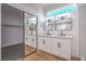 Bright bathroom features double sinks, modern vanity, and a mirrored closet at 5321 Marietta Ave, Las Vegas, NV 89108