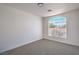 A bright bedroom features neutral carpet, white walls, and an arched window at 5321 Marietta Ave, Las Vegas, NV 89108