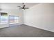 Bright bedroom features neutral carpet, ceiling fan, and sliding glass doors to the backyard at 5321 Marietta Ave, Las Vegas, NV 89108