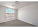 Bright bedroom features neutral carpet, white walls, and an arched window at 5321 Marietta Ave, Las Vegas, NV 89108