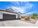 Front exterior of house with tile roof, desert landscaping and long driveway at 5321 Marietta Ave, Las Vegas, NV 89108