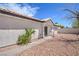 Side view of exterior showing textured facade, side-yard landscaping, and covered entryway at 5321 Marietta Ave, Las Vegas, NV 89108