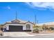 Inviting single-story house with a brown garage door, tile roof, and desert landscaping at 5321 Marietta Ave, Las Vegas, NV 89108