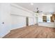 Open living room with wood floors, fan, and white accents at 5321 Marietta Ave, Las Vegas, NV 89108