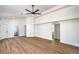 Spacious living room with wood floors, white walls, and ceiling fan at 5321 Marietta Ave, Las Vegas, NV 89108