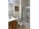 Bathroom features toilet with bidet, decorative glass shower-tub combo, and vanity with white countertop at 5334 Floating Flower Ave, Las Vegas, NV 89139