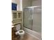 Bathroom features a shower-tub combo with decorative glass door, cabinet and toilet with bidet at 5334 Floating Flower Ave, Las Vegas, NV 89139
