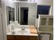 Bathroom features a vanity with double mirrors, sink and toilet with decorative glass shower-tub combo at 5334 Floating Flower Ave, Las Vegas, NV 89139