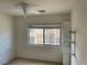 Bedroom features large window with blinds, a ceiling fan and a closet with shelving at 5334 Floating Flower Ave, Las Vegas, NV 89139