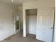 A bedroom featuring a closet, doors, neutral carpet and white walls at 5334 Floating Flower Ave, Las Vegas, NV 89139