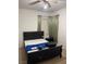 Bedroom featuring a black bed frame, window with curtains, and a ceiling fan for a comfortable atmosphere at 5334 Floating Flower Ave, Las Vegas, NV 89139