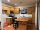 Traditional kitchen with wood cabinets, stainless steel appliances, and a convenient center island at 5334 Floating Flower Ave, Las Vegas, NV 89139