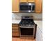 Close-up view of modern stainless steel gas range and microwave in the kitchen area at 5334 Floating Flower Ave, Las Vegas, NV 89139