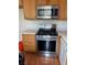 Close-up view of modern stainless steel gas range and microwave in the kitchen area at 5334 Floating Flower Ave, Las Vegas, NV 89139