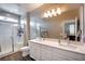 Modern bathroom with double vanity, quartz countertops, shower, and wood-look flooring at 541 Tokopah Falls St, Las Vegas, NV 89138