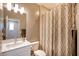 Full bath features a shower with decorative curtain and vanity with a framed mirror at 541 Tokopah Falls St, Las Vegas, NV 89138