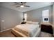 Spacious bedroom featuring carpet, ceiling fan, bedside tables and lamps, and large windows at 541 Tokopah Falls St, Las Vegas, NV 89138