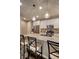 Kitchen island with granite countertops and pendant lighting above provides seating at 541 Tokopah Falls St, Las Vegas, NV 89138