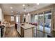 Bright kitchen with an island, stainless appliances, and open access to a cozy living area and outdoor patio at 541 Tokopah Falls St, Las Vegas, NV 89138