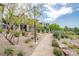 Community landscaping with walking path, rocks, trees and flowers surrounding homes at 541 Tokopah Falls St, Las Vegas, NV 89138