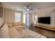 Comfortable living room featuring plush sofa, a modern TV console, and staircase at 541 Tokopah Falls St, Las Vegas, NV 89138