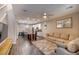 Bright open-concept living space with modern furnishings, wood floors, and an island with bar seating at 541 Tokopah Falls St, Las Vegas, NV 89138
