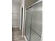 Bathroom featuring glass shower doors and wood look tile at 6092 Fox Creek Ave, Las Vegas, NV 89122