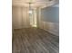 Formal dining room with hardwood flooring and modern chandelier at 6092 Fox Creek Ave, Las Vegas, NV 89122
